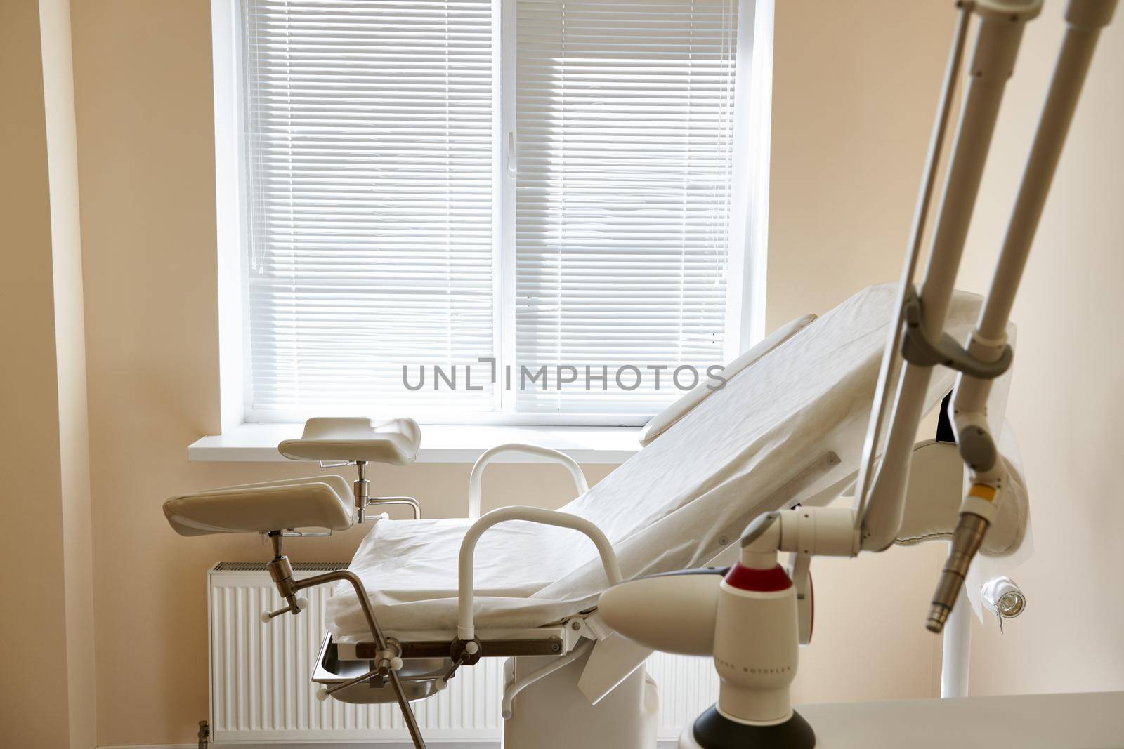 Gynecological chair in the clinic. Gynecology room, medical instruments, interior of the genicological clinic