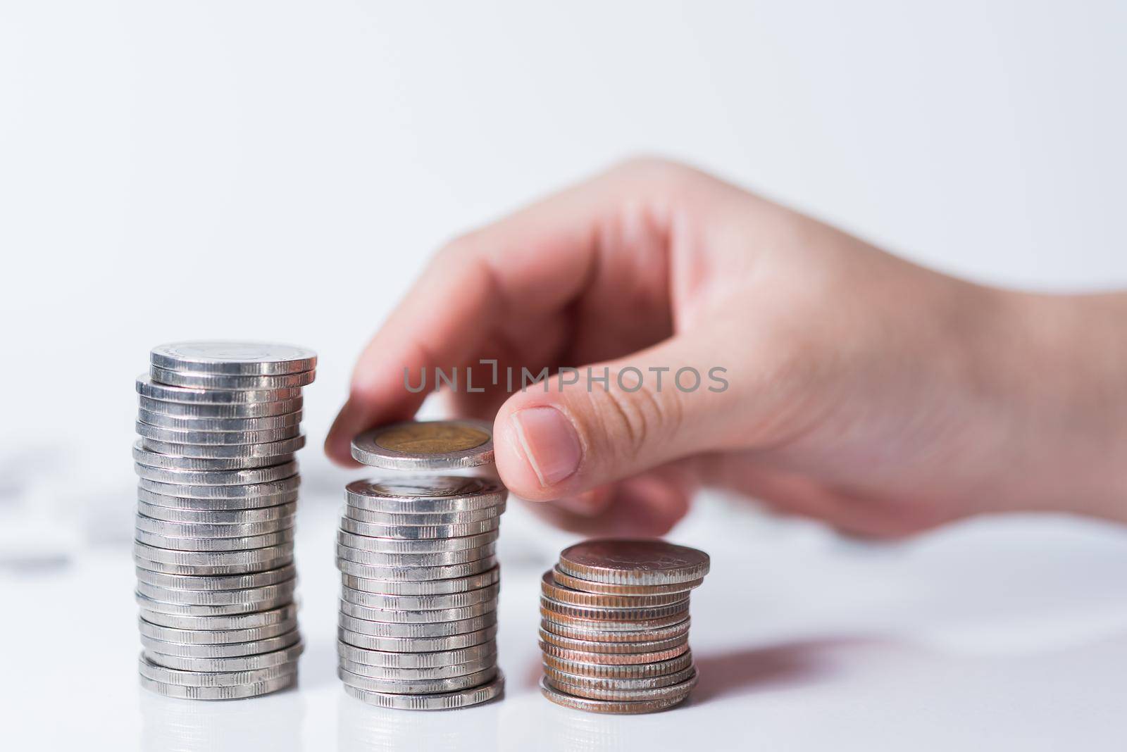 hand putting coin on white background, Saving money