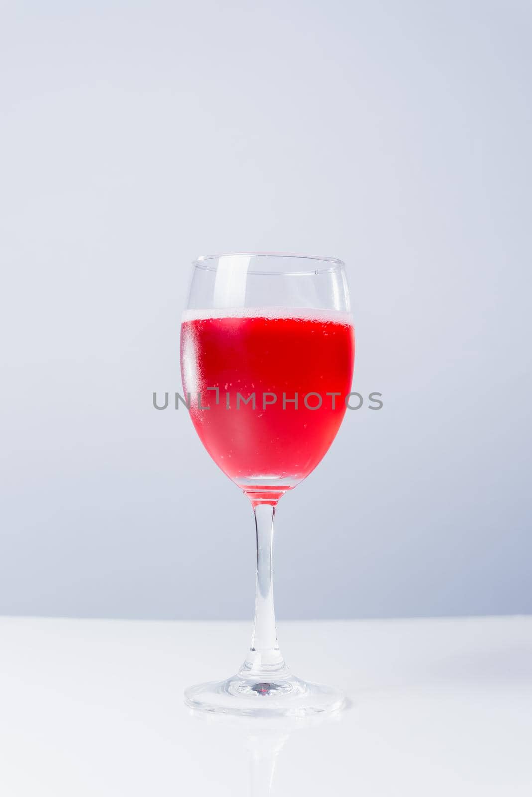 isolated glass with red wine on white background by Wmpix