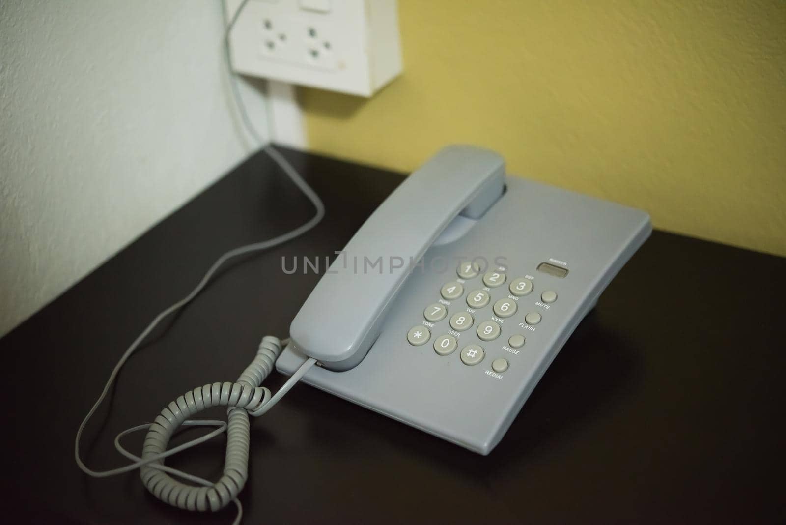 Vintage Phones - gray a retro telephone on a wooden table by Wmpix