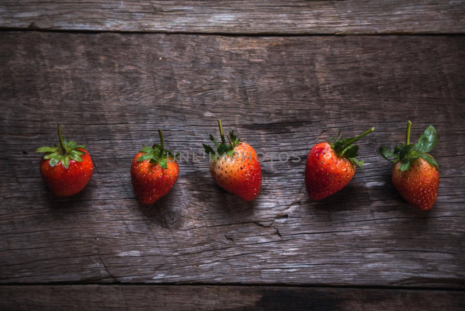 Fresh strawberry on wooden background. Top view, flat lay