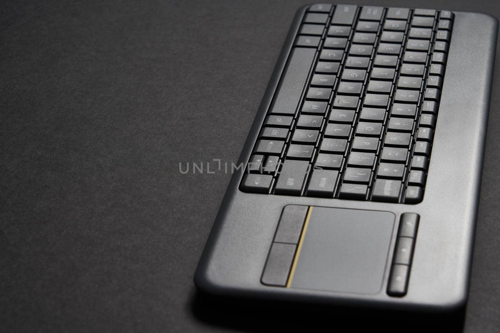 Computer keyboard over a black background with copy space