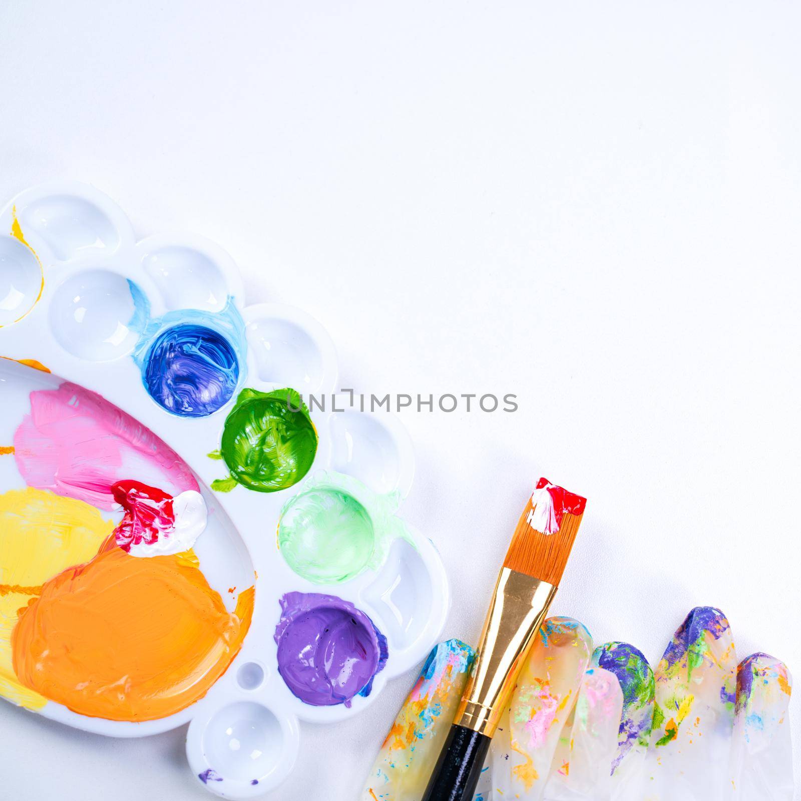 Design concept - Preparing for Easter celebration, painting Easter eggs with colorful Acrylic pigment color dyestuff in palette, top view, lifestyle. by ROMIXIMAGE