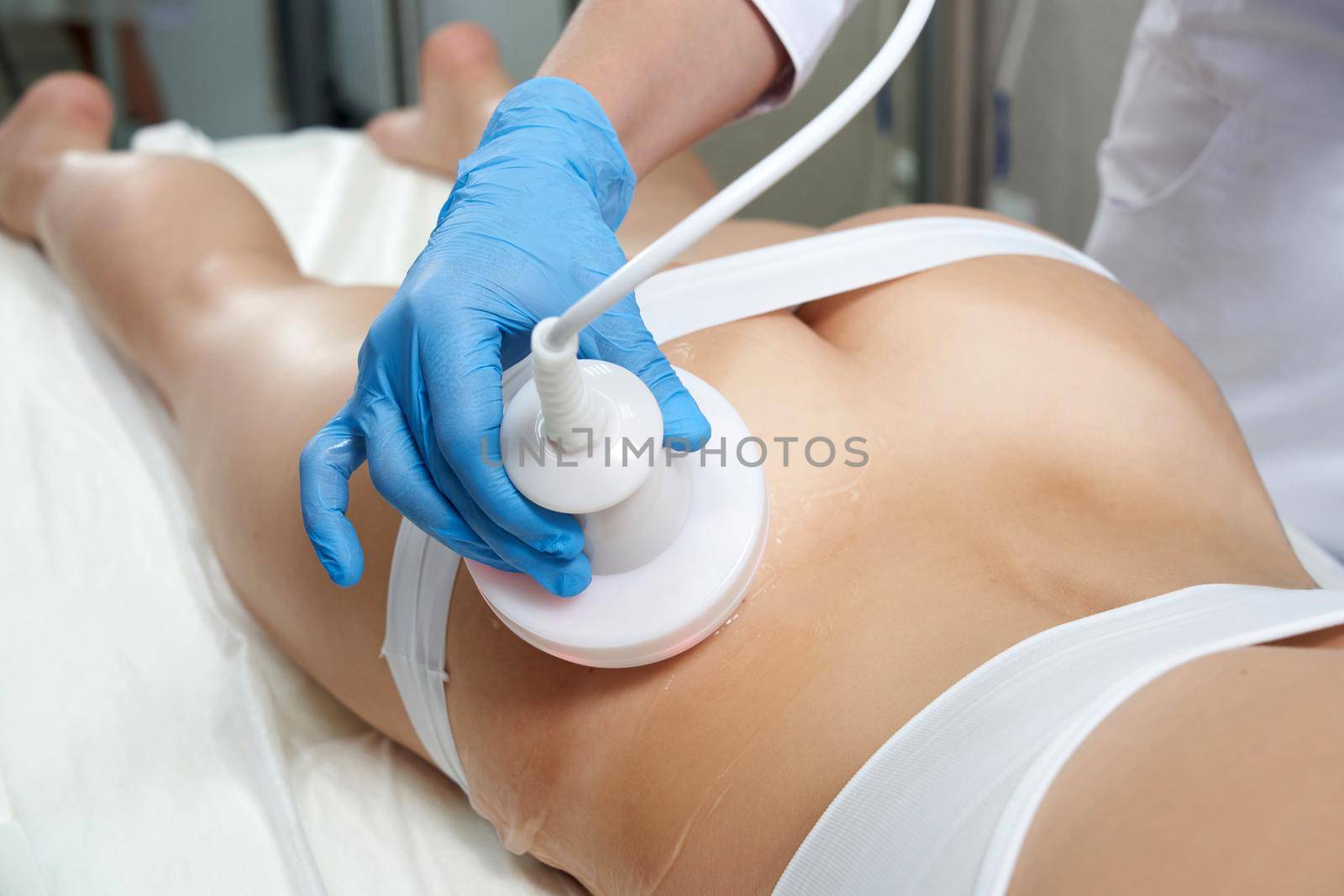 Hardware cosmetology. Body care. Spa treatment. Ultrasound cavitation body contouring treatmentWoman getting anti-cellulite and anti-fat therapy in beauty salon.