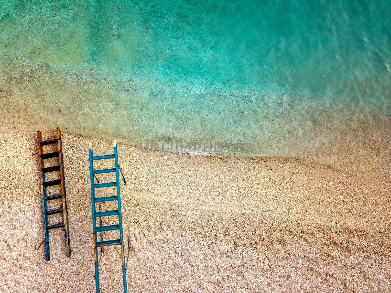 Top view of a beautiful tropical empty beach with two ladders for tourist boat.