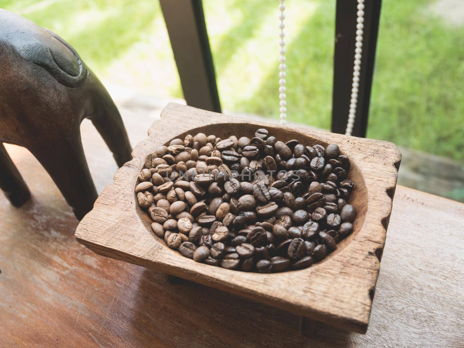 coffee beans on wood table by Wmpix