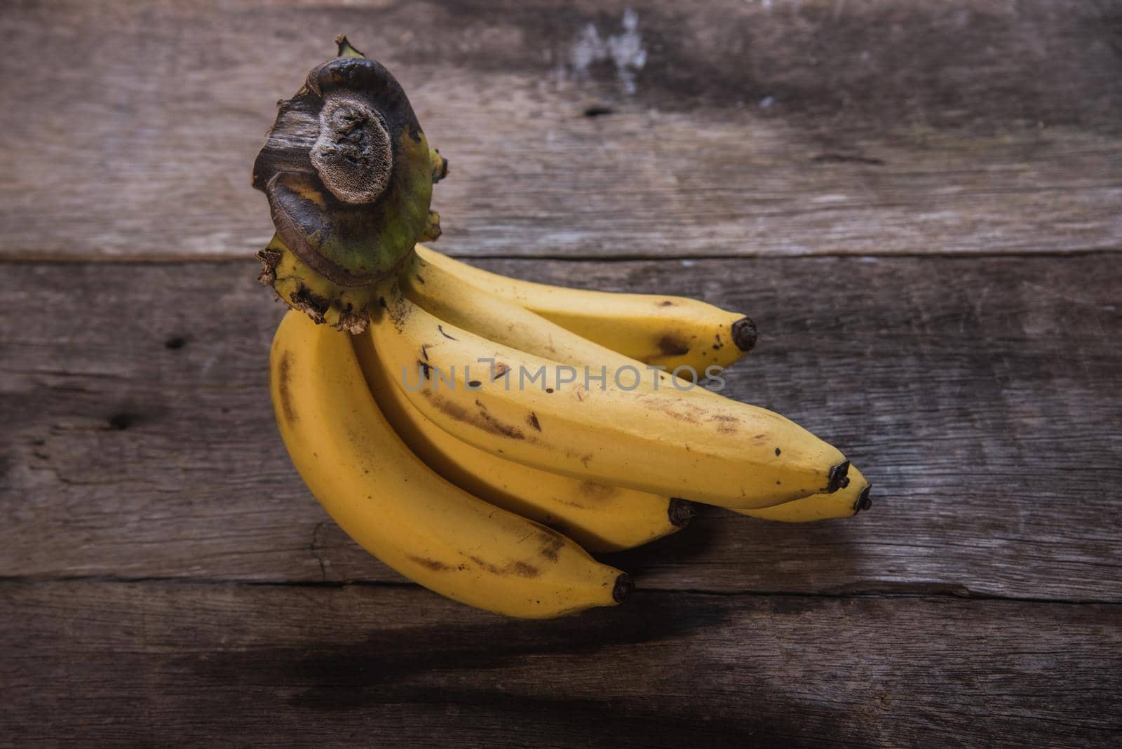 Fresh bananas on wooden background by Wmpix
