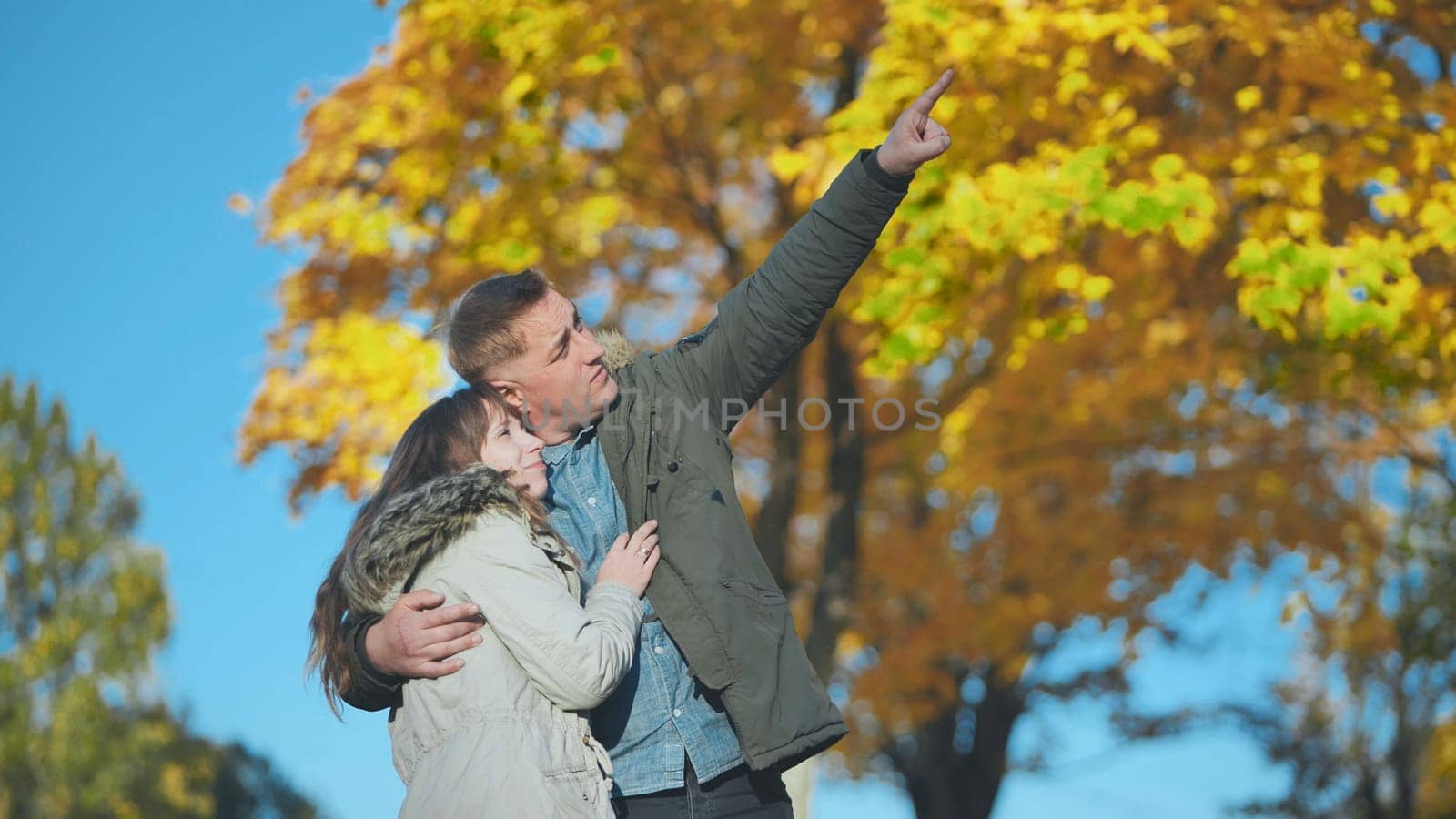 Happy and in love young couple in the park in the fall