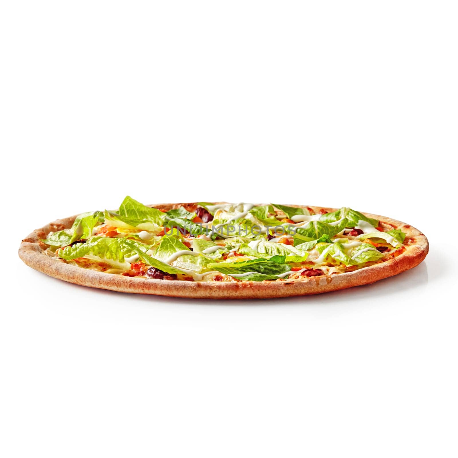 Delicious thin pizza with browned crispy edge with chicken fillet, tomatoes, red beans topped with fresh Romaine lettuce and cream cheese sauce, isolated on white background. Italian style cuisine