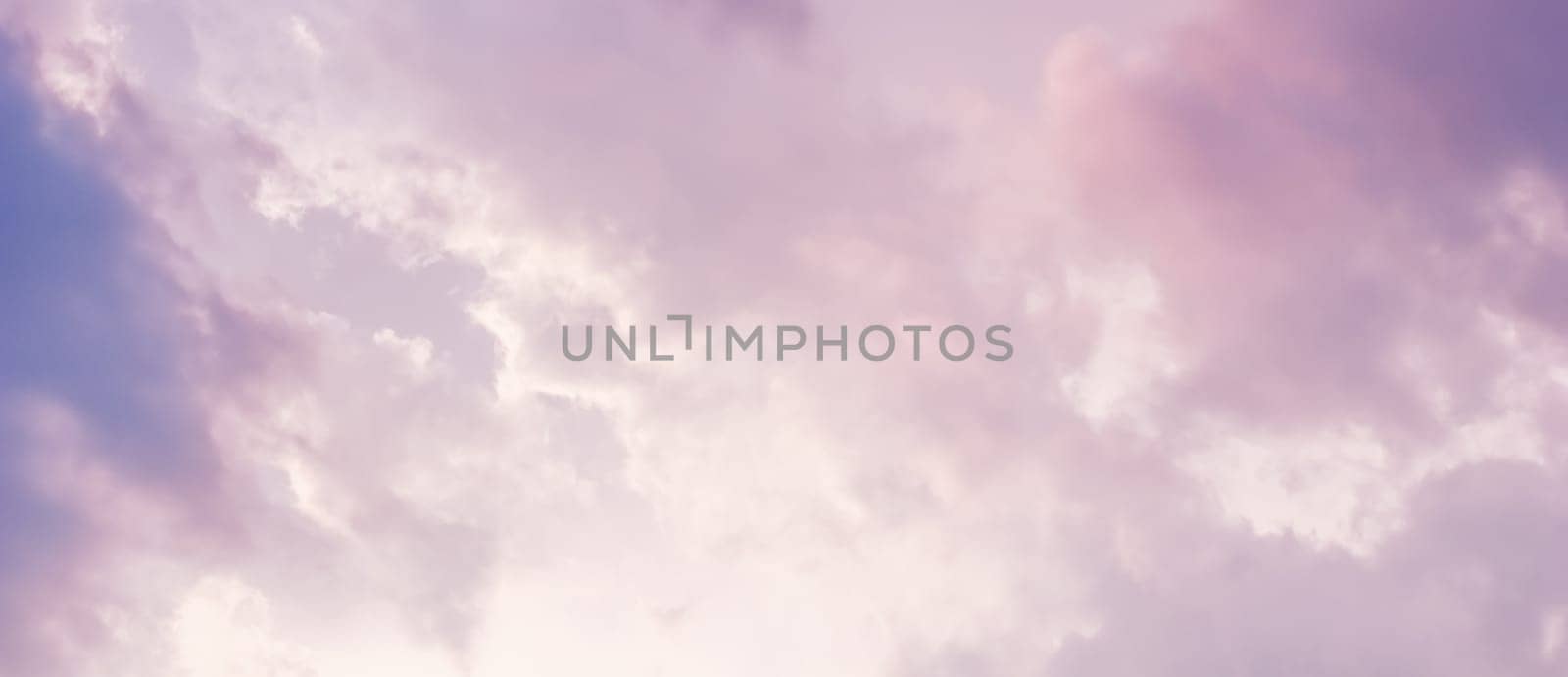 Background of a beautiful pink and pale purple sky with clouds at sunset. High quality photo