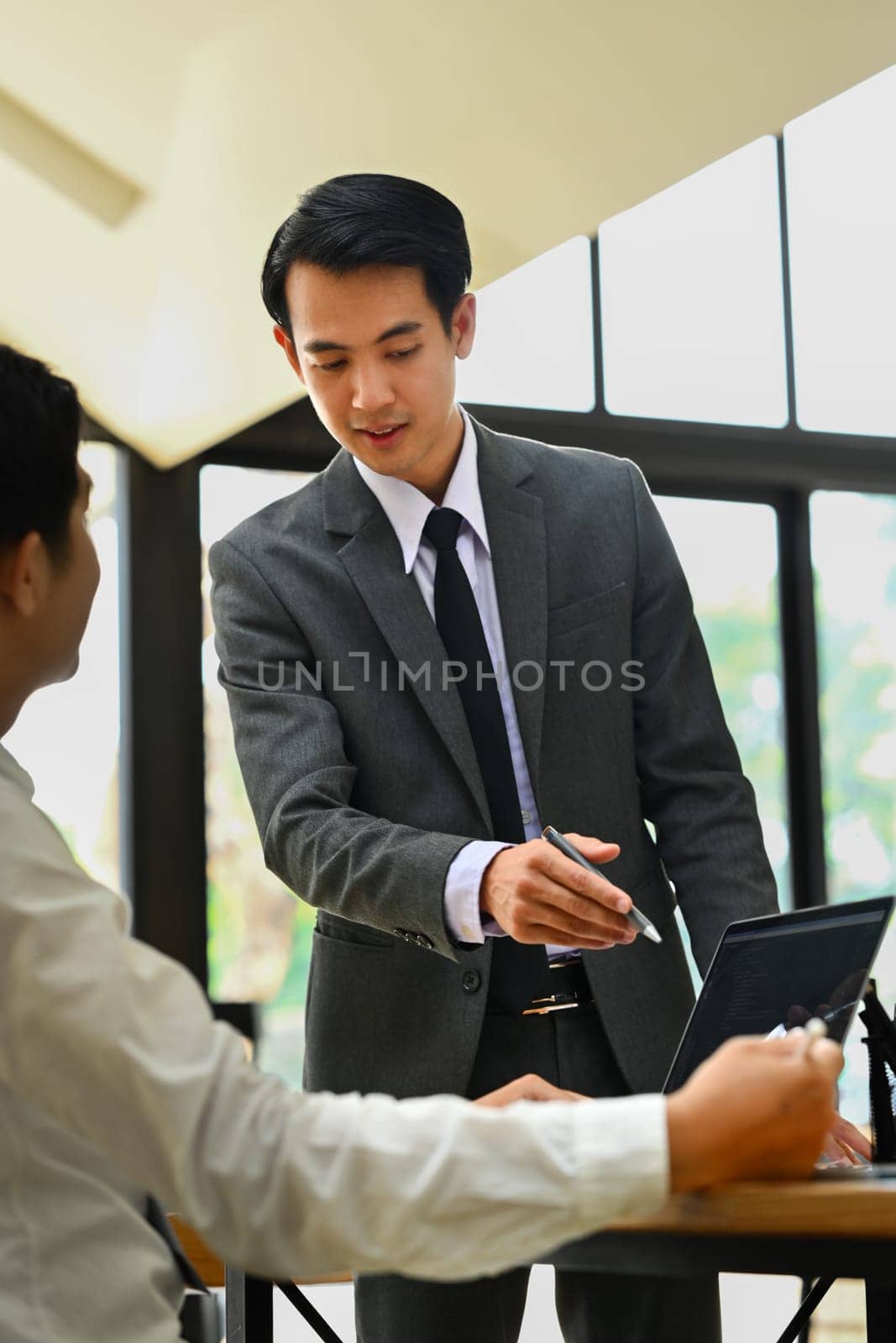 Shot of businessman explaining information, talking about company strategy and business plan during meeting.