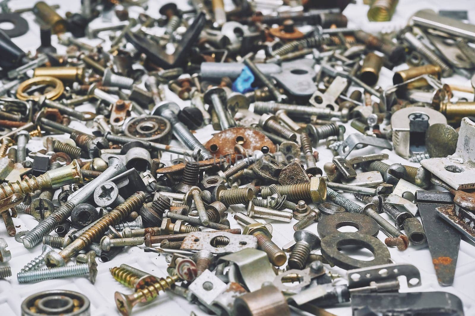 Iron sundries,mess.Various metal bolts, nuts, washers, fasteners scattered by jovani68