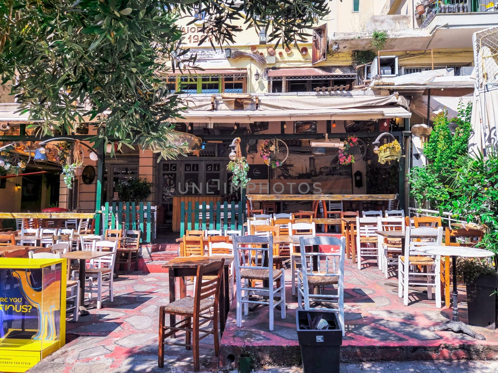 Day view of the empty traditional outdoor seating area of taverns with colorful chairs, tables and vintage decoration at the historic Bit Bazaar area.
