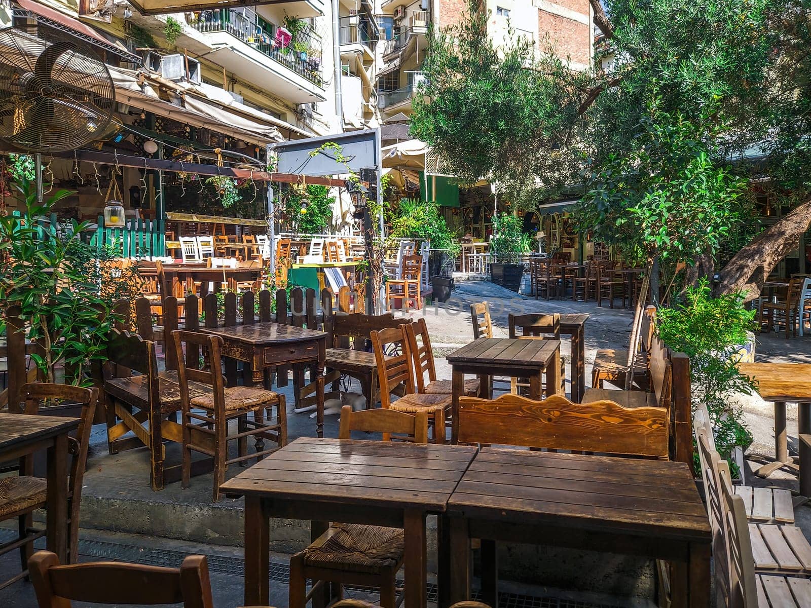 Day view of the empty traditional outdoor seating area of taverns with colorful chairs, tables and vintage decoration at the historic Bit Bazaar area.