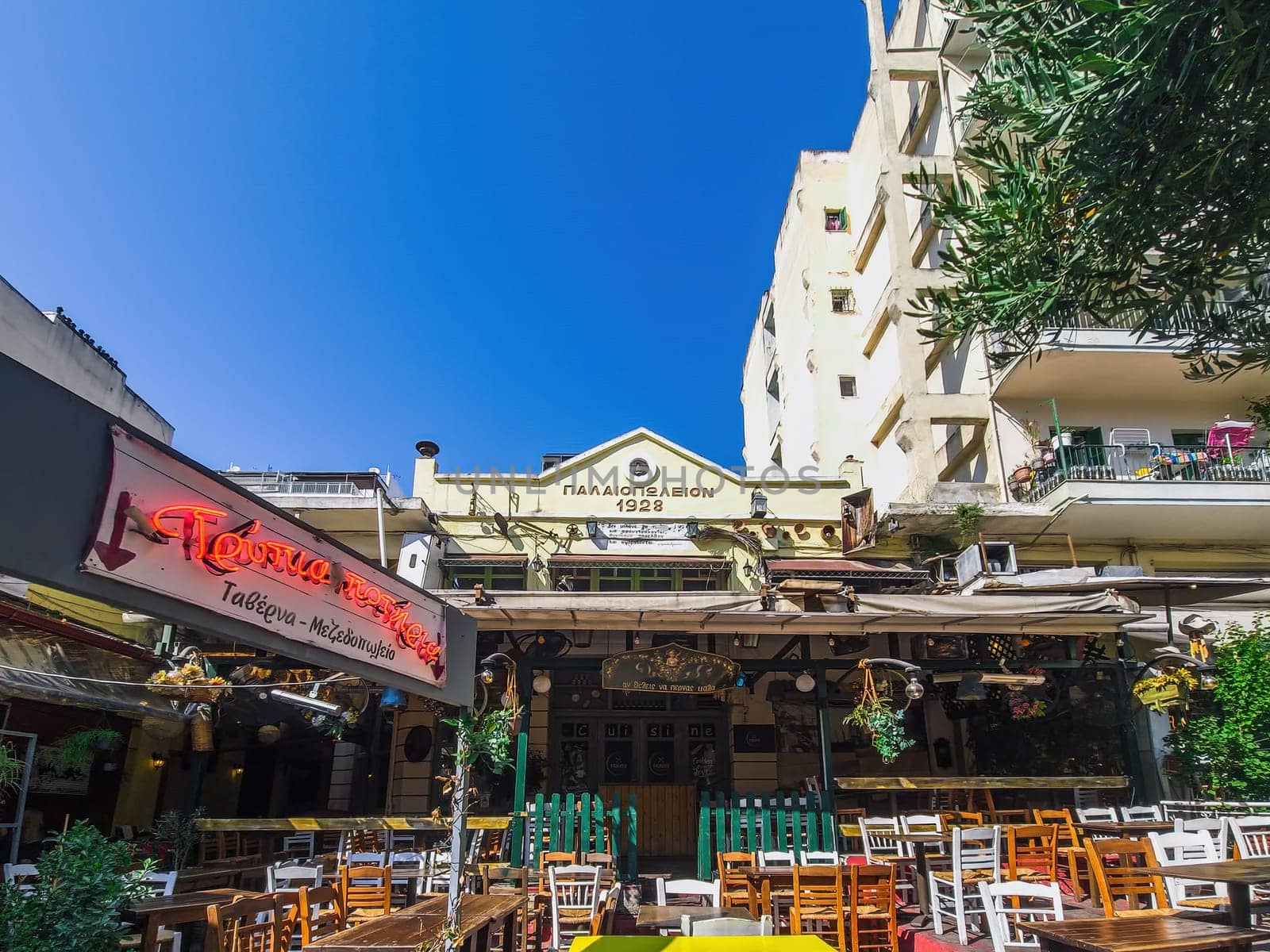 Day view of the empty traditional outdoor seating area of taverns with colorful chairs, tables and vintage decoration at the historic Bit Bazaar area.