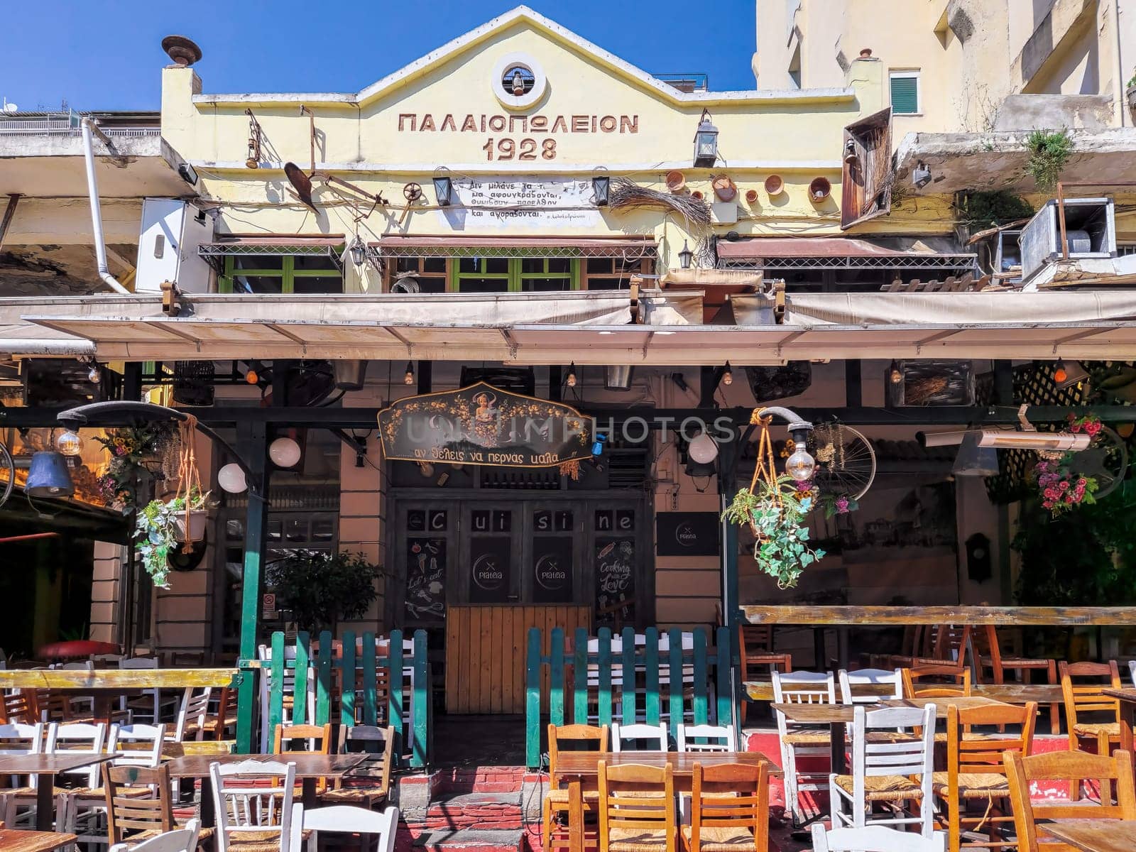 Day view of the empty traditional outdoor seating area of taverns with colorful chairs, tables and vintage decoration at the historic Bit Bazaar area.