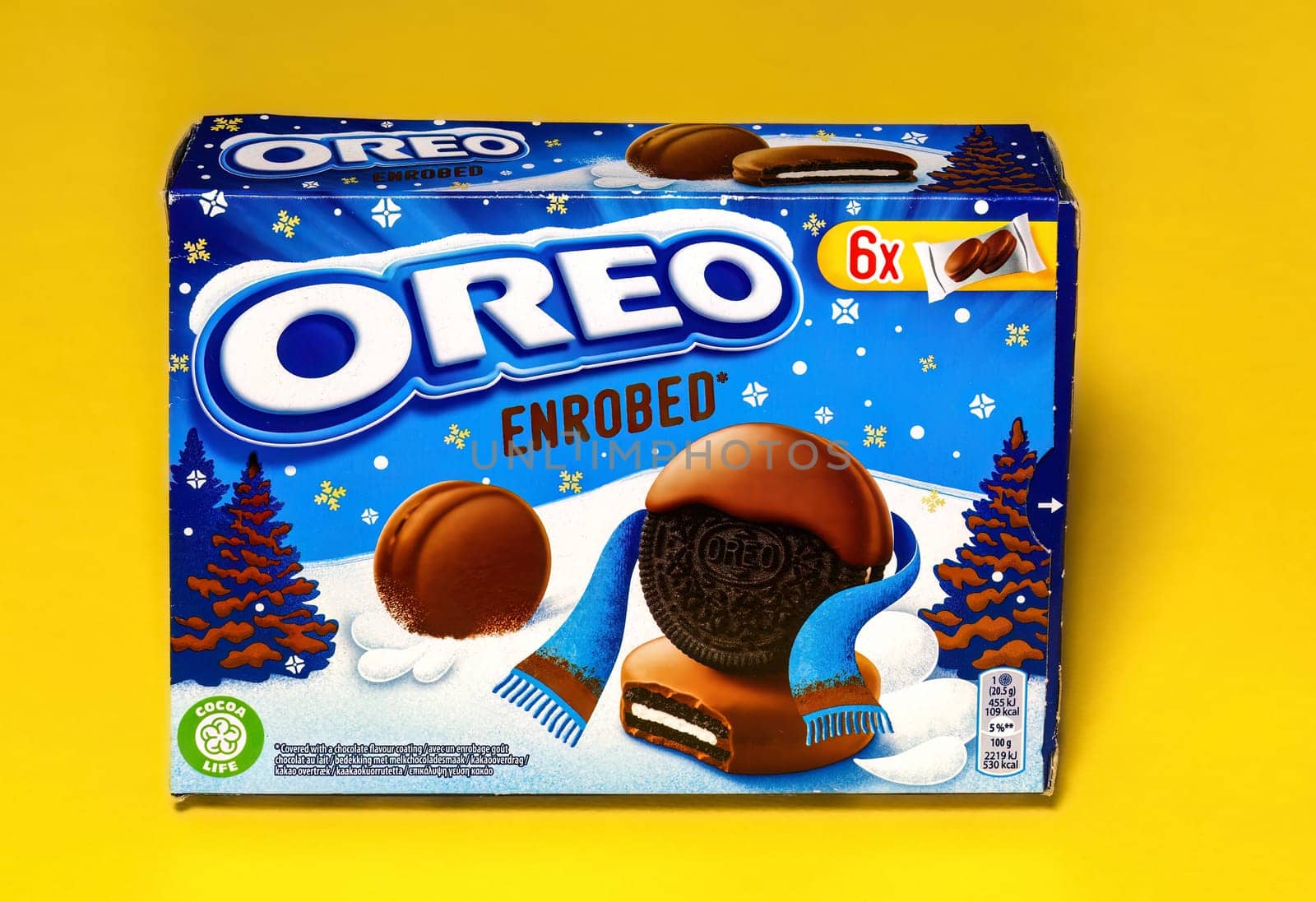 Oreo Enrobed, a classic cookie variation dessert of a biscuit with creamy chocolate on the packaging with nutrition details against a yellow background.