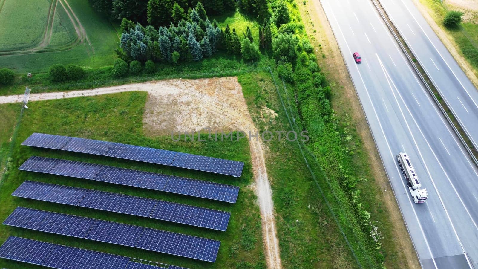 Aerial view of the A7 motorway in northern Germany with big solar panel areas close to the highway. by MP_foto71