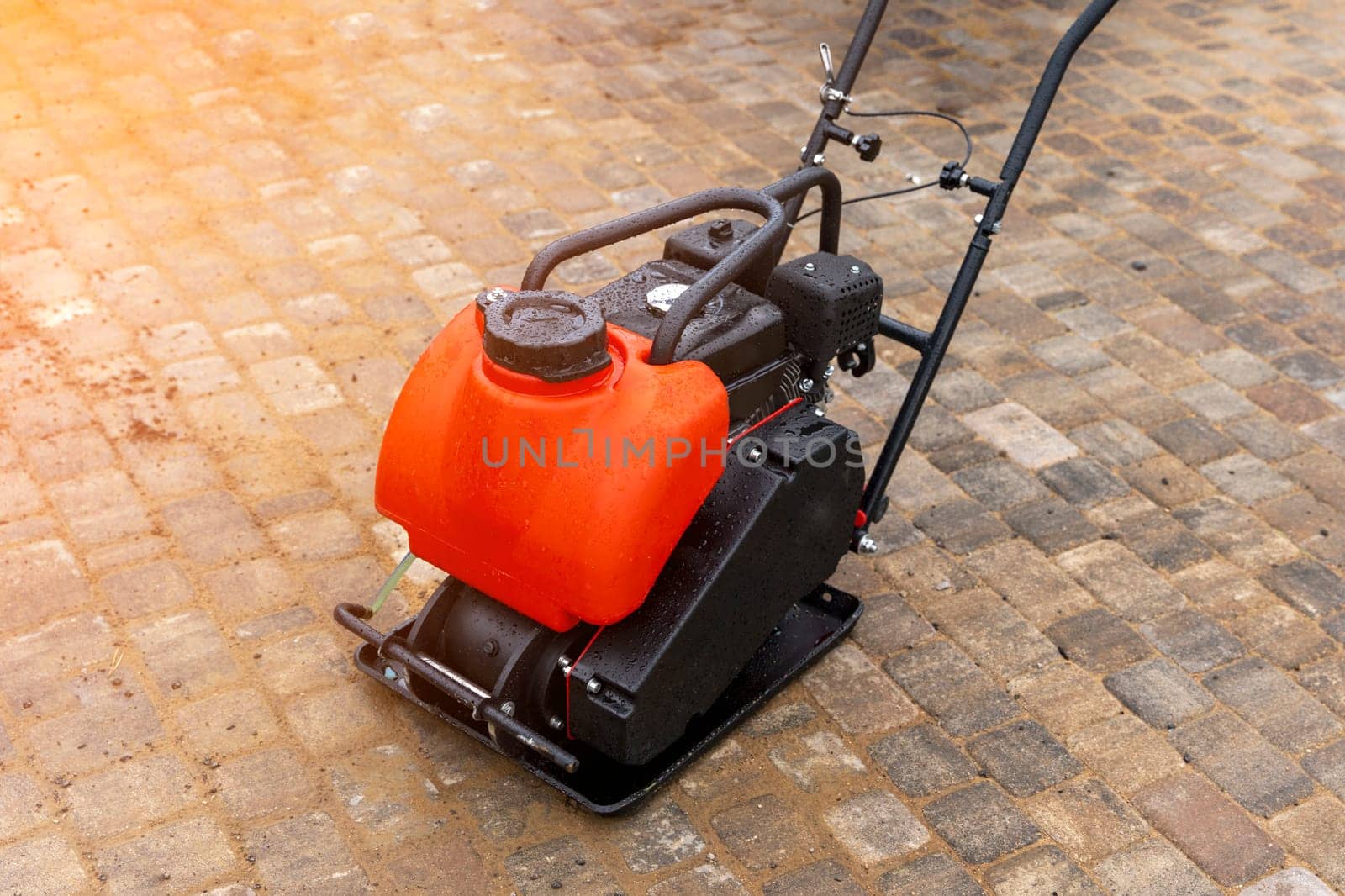 Gasoline Vibrating rammer with a vibrating plate on construction site by audiznam2609