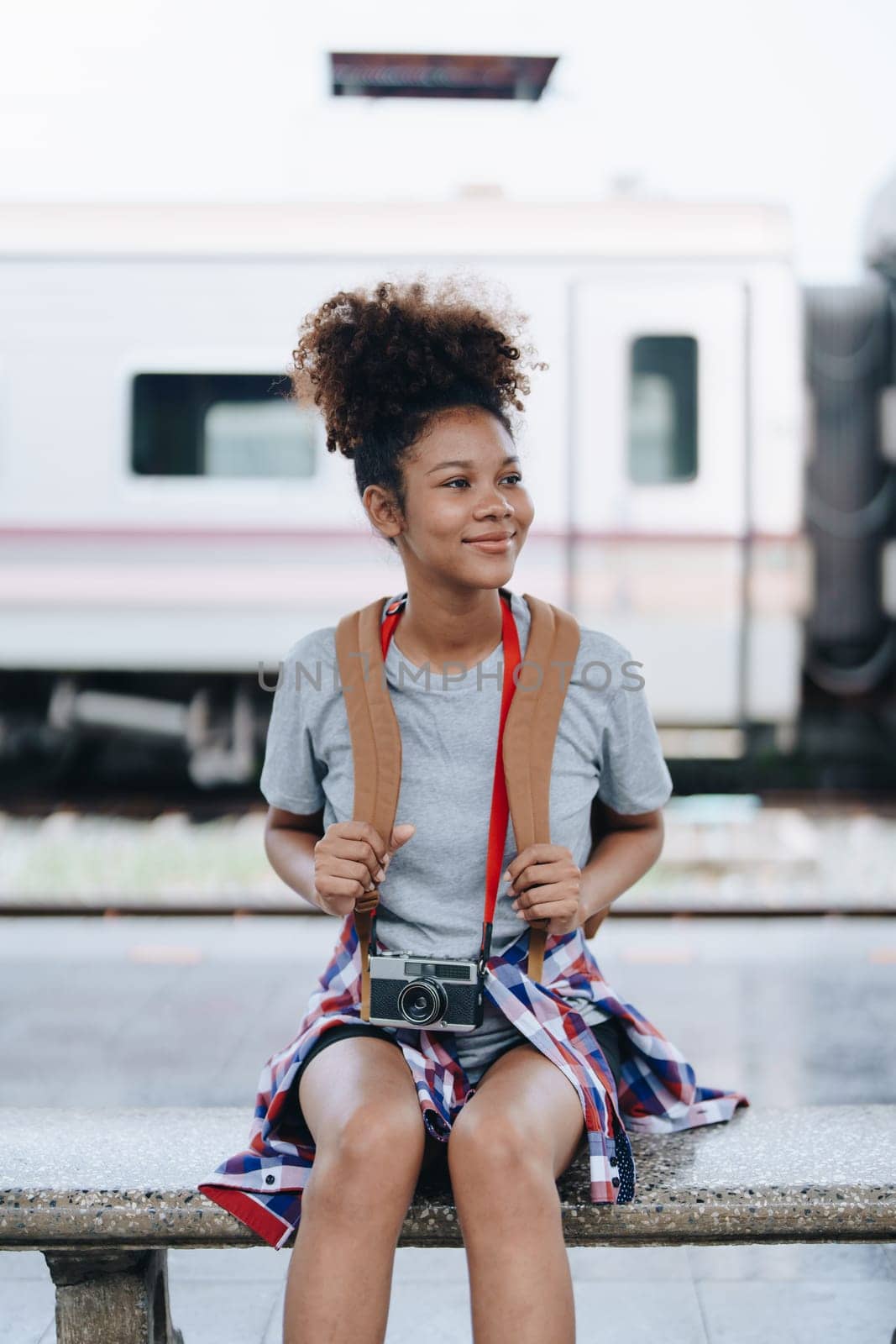 Tourists african american are showing happy expressions while waiting for their journey in the train station