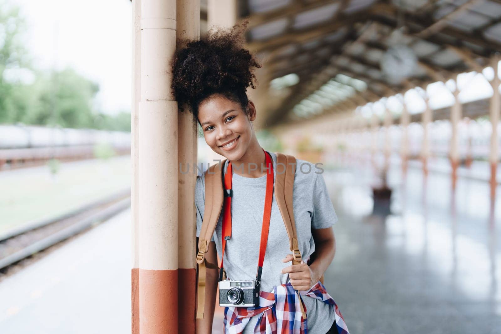 Tourists african american are showing happy expressions while waiting for their journey in the train station