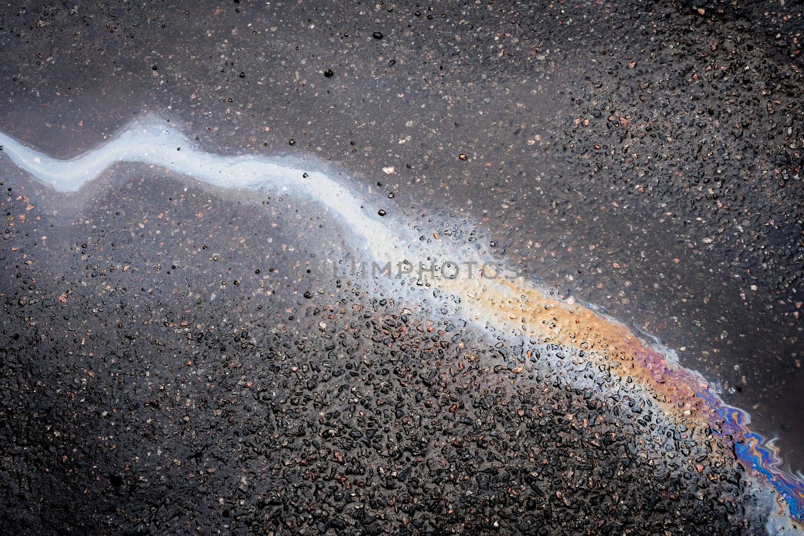 .Abstract background from motor oil, gas or petrol spilled on asphalt. Concept of environmental problems.