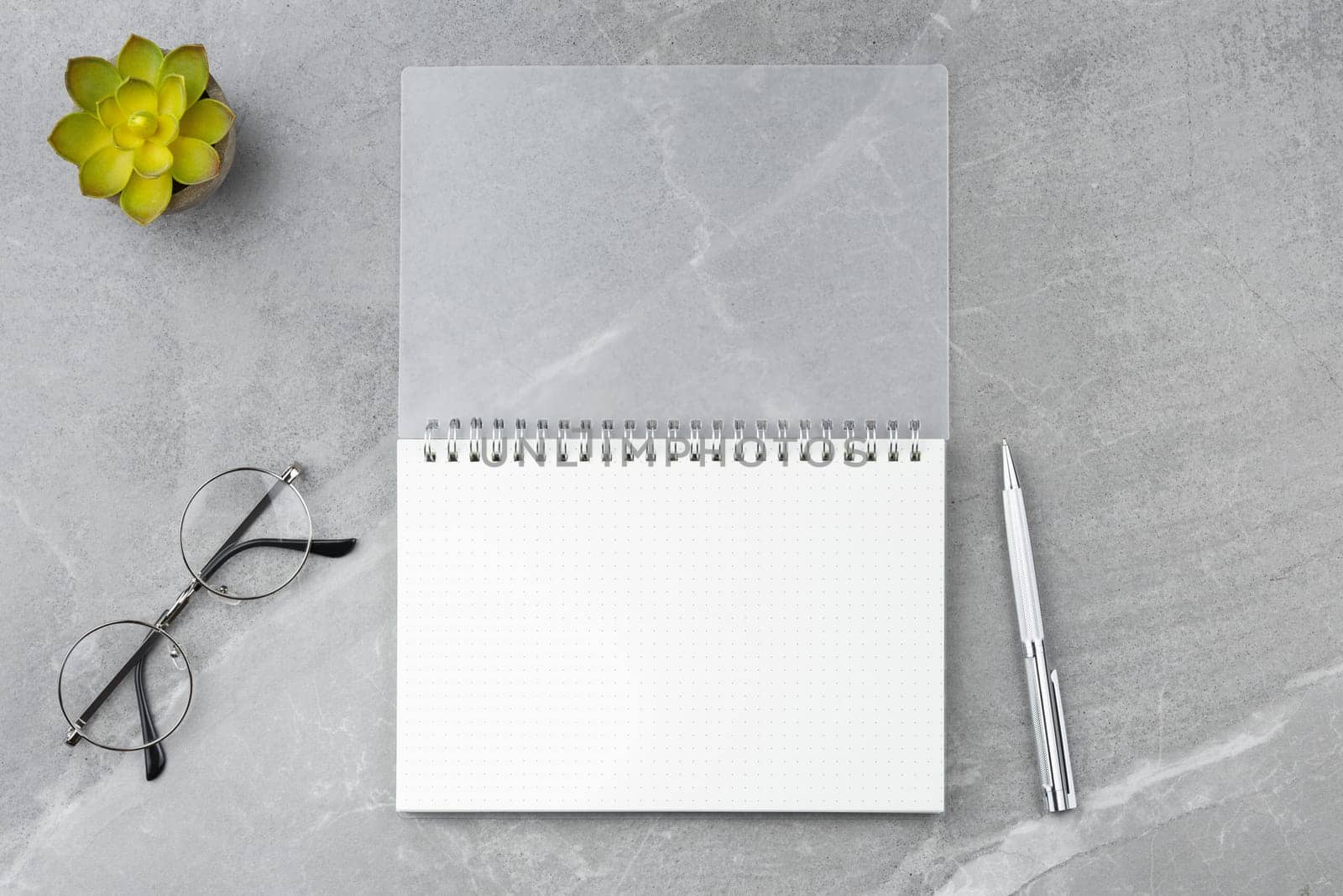 Notepad with a pen on a marble background. by alexxndr