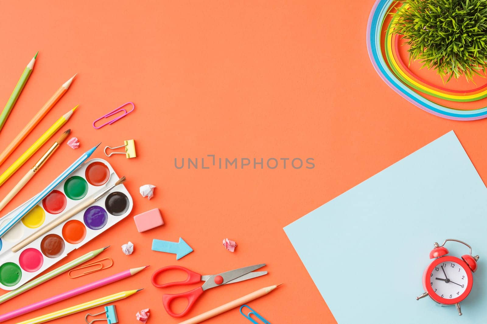 Paints, colored pencils, scissors, paper clips, rubber bands. Painting tools. Stationery. Bright collage, top view concept of a creative work table.