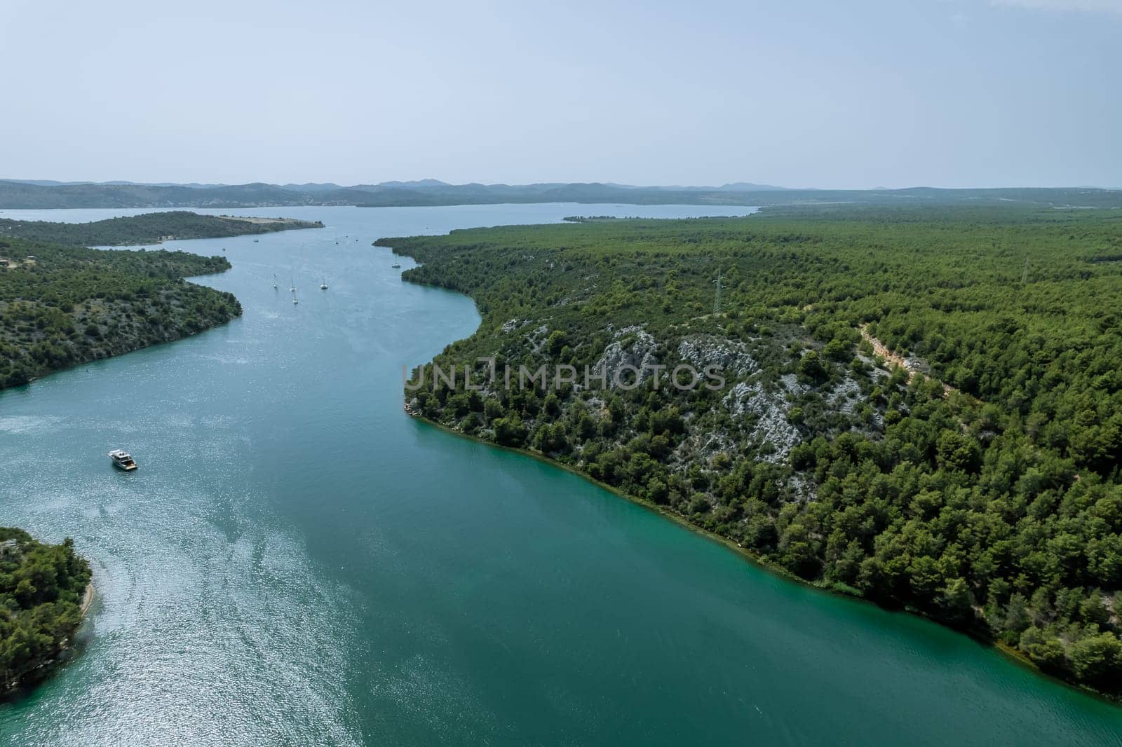 Shimmering waters of Adriatic Sea glisten beneath nature, creating a harmonious visual experience.