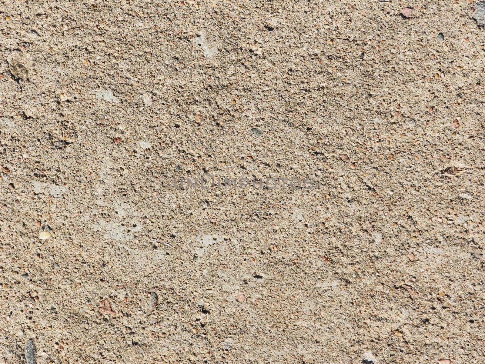 Abstract background made of concrete wall. Rough light brown concrete wall close-up.