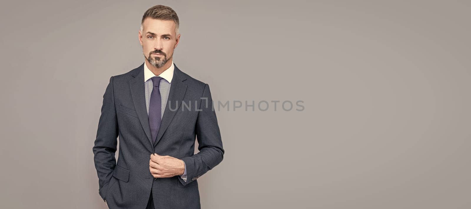 charismatic businessman man in businesslike suit, charisma. Man face portrait, banner with copy space. by RedFoxStudio