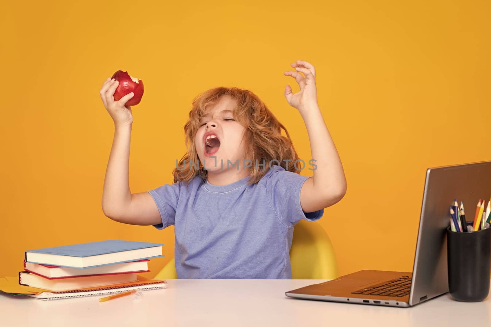 Excited funny pupil. Little student school child isolated on studio background. Portrait of nerd student with school supplies