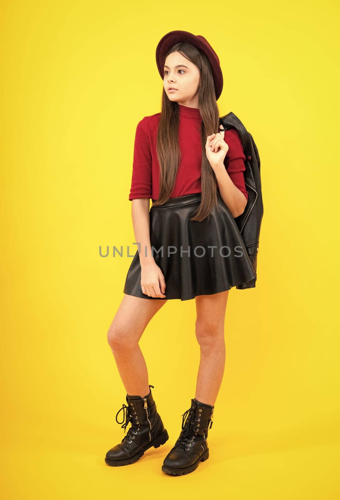 Full length photo of pretty teenager child girl wear casual clothes isolated on yellow background. by RedFoxStudio