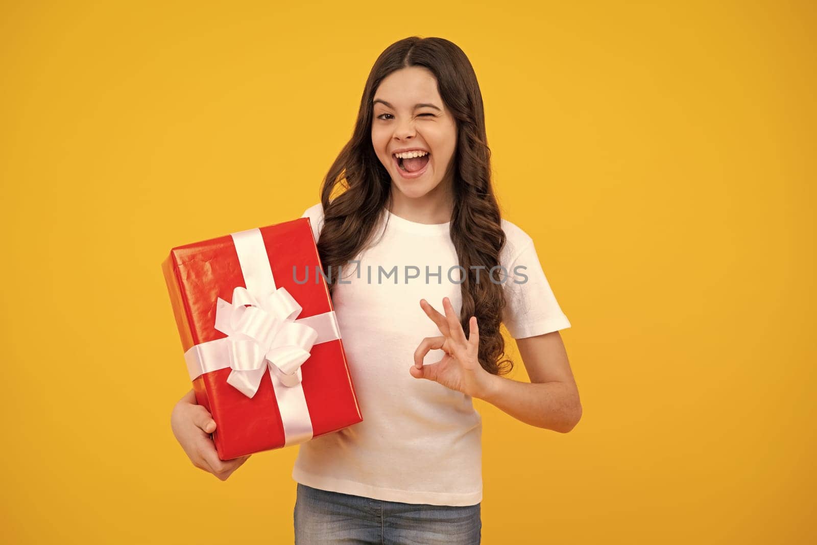 Amazed teenager. Teenager child with gift box. Present for winter birthday, Valentines day, New Year or Christmas. Excited teen girl. by RedFoxStudio