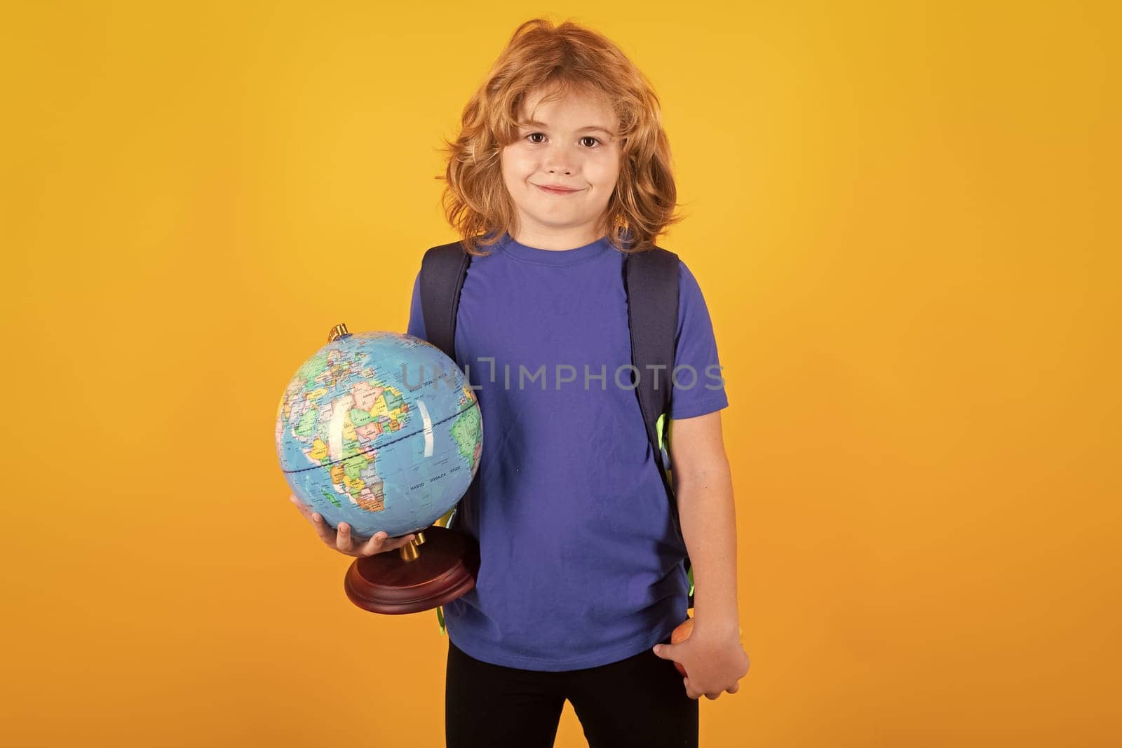 Back to school. Portrait of cute child school boy. School and education kids concept. Clever kid with school supplies isolated on yellow studio background