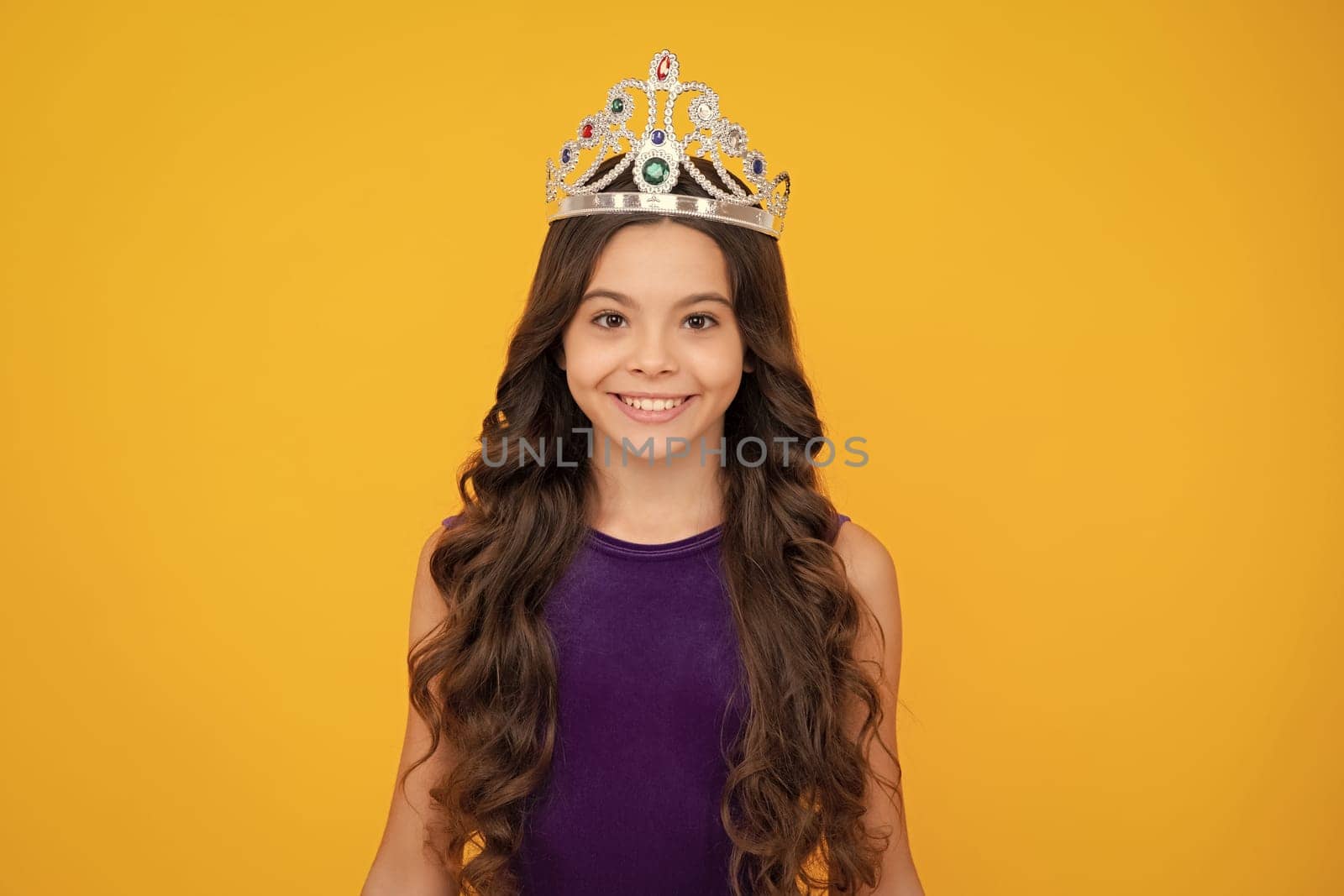 Girls birthday party, funny kid in crown. Imagine herself a queen, child wear diadem. Successful teenager wear luxury beauty queen crown, success. Happy girl face, positive and smiling emotions