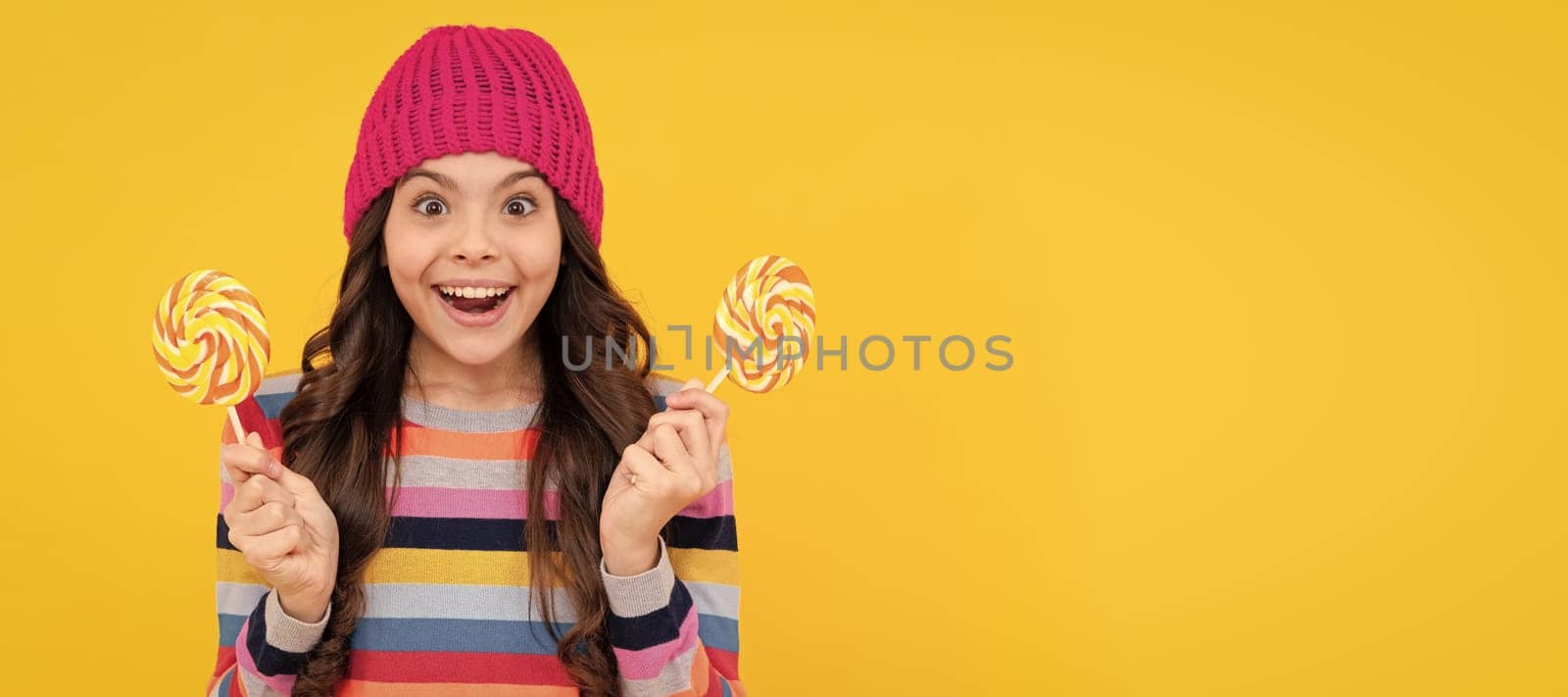 surprised teen girl with lollipop candy, happiness. Teenager child with sweets, poster banner header, copy space. by RedFoxStudio