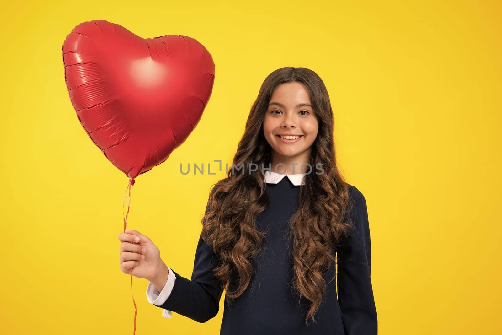 Lovely child girl 12, 13, 14 years old with shape heart balloon, love holiday and valentine symbol. Valentine or birthday day. by RedFoxStudio