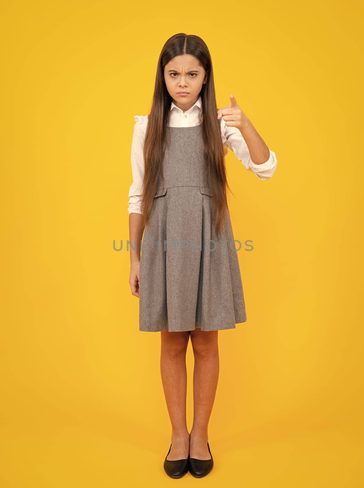 Full length of pretty cheerful teenager girl having fun good mood and posing in casual clothes isolated over yellow background. by RedFoxStudio