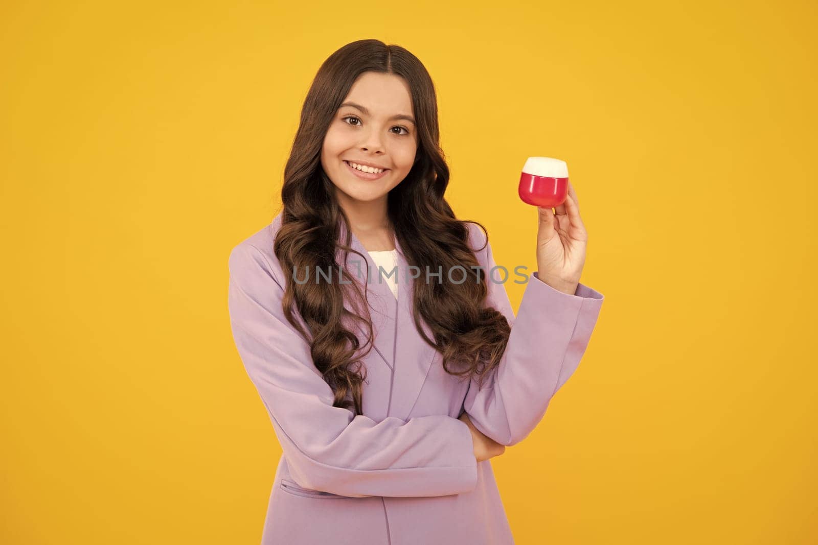 Teen girl hold facial cleaner for skin wash. Skin care. Child presenting cosmetic product for teen. Kid use face cream. by RedFoxStudio