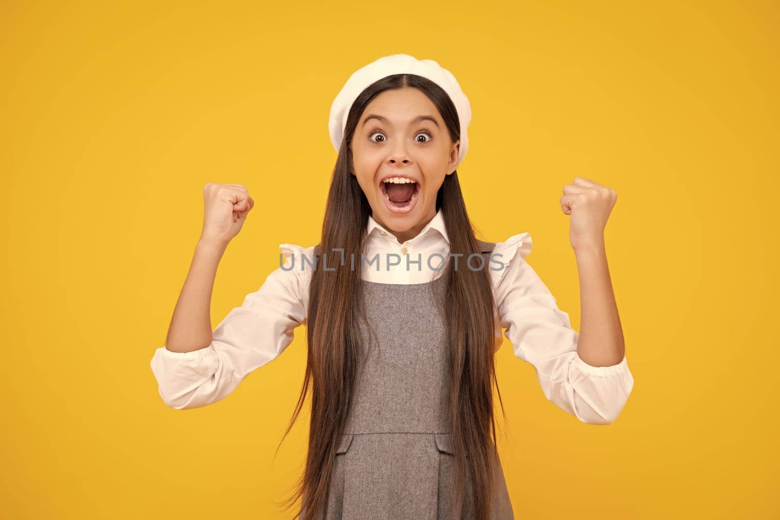 Happy face, positive and smiling emotions of teenager girl. Excited expression, cheerful and glad. Teenager child doing winner gesture celebrate clenching, say yes. by RedFoxStudio