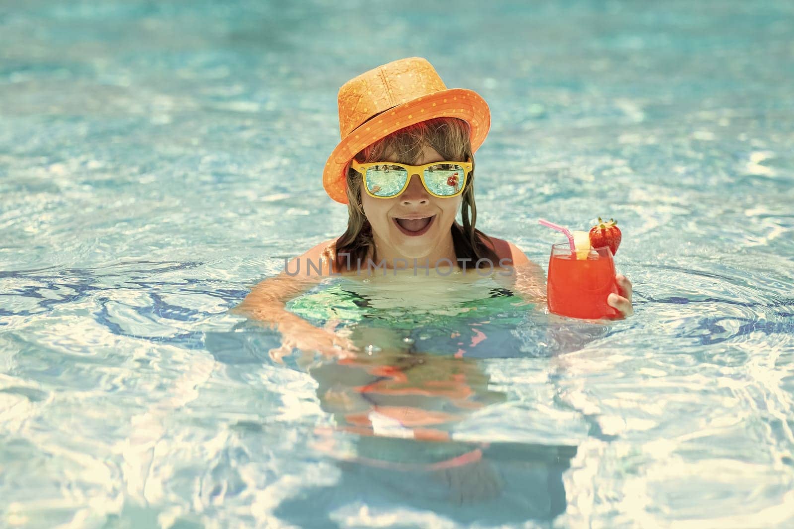 Kid boy drinking coctail in the pool. Little child boy in swimming pool. Kids swim on summer vacation. Beach sea and water fun. Summer kids cocktail