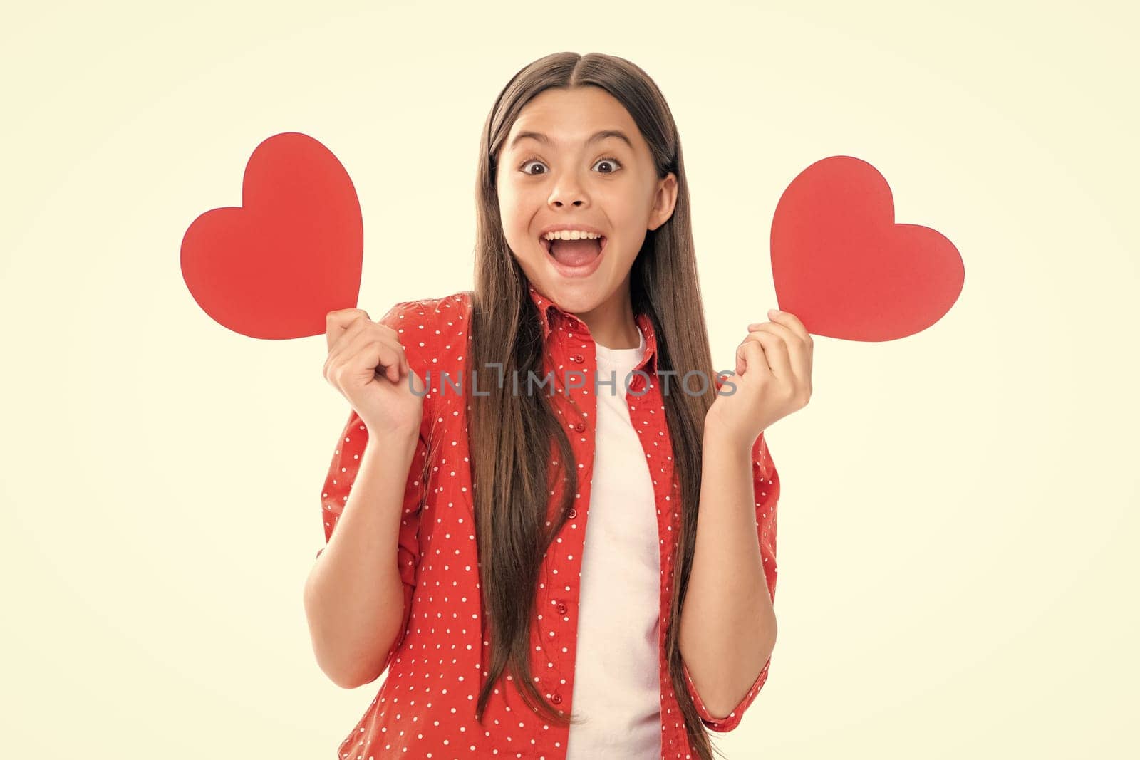 Lovely child girl 12, 13, 14 years old with shape heart love holiday and valentine symbol. Valentine or birthday day. Portrait of emotional amazed excited teen girl