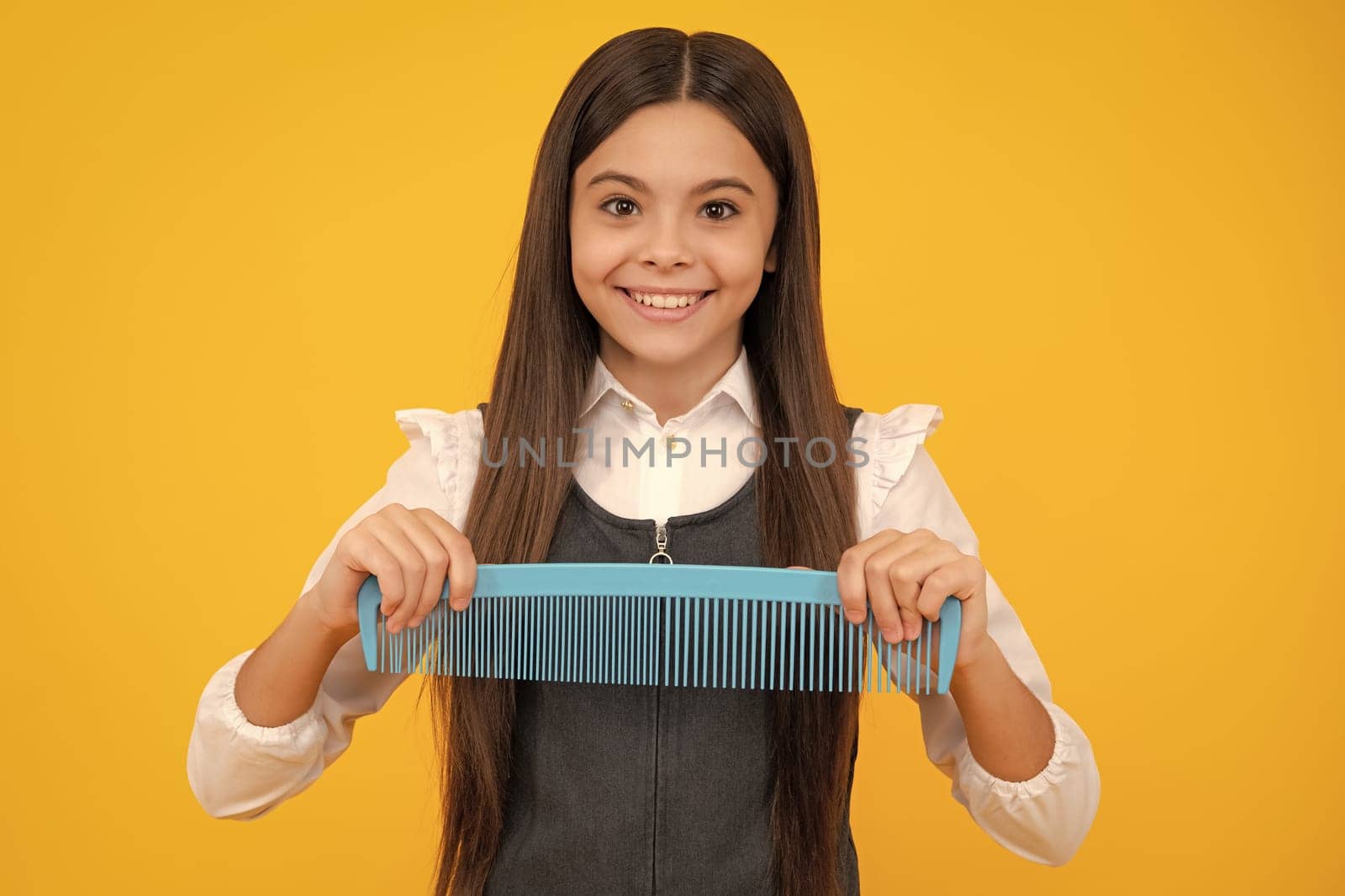 Teen girl girl with brush combing hair. Girl taking haircare and hairstyle. Hairdresser hair solon for teenager