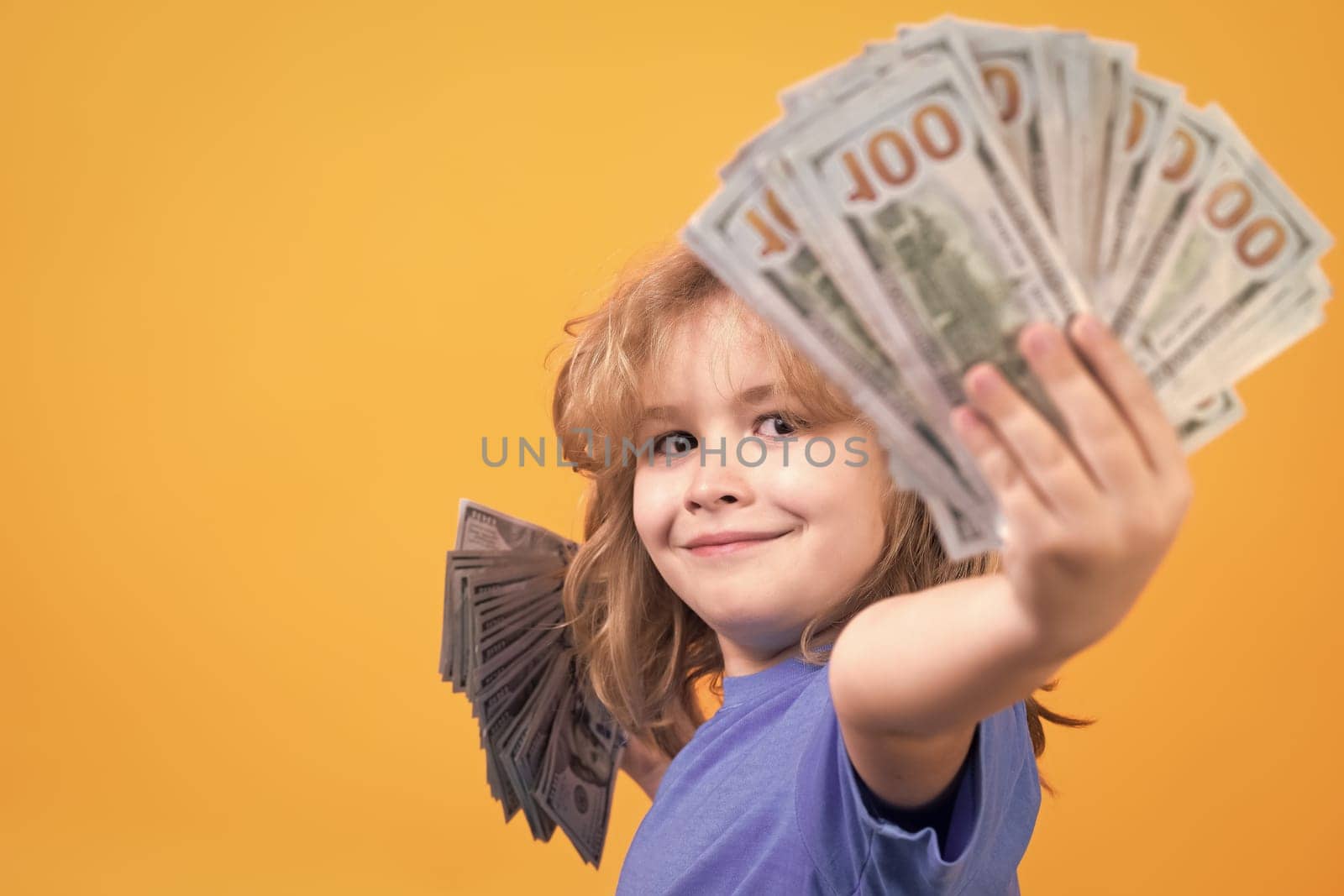 Rich child with dollars. Lottery cashback, win big money isolated yellow background