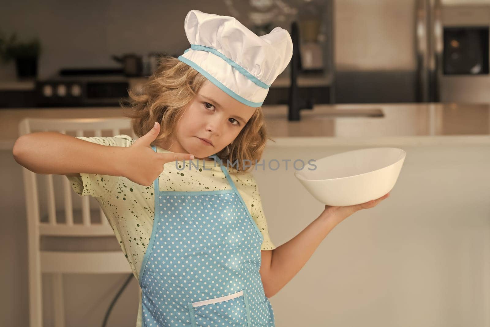 Chef kid cook baking at home kitchen. Kid chef cook cookery at kitchen. Cooking, culinary and kids. Little boy in chefs hat and apron