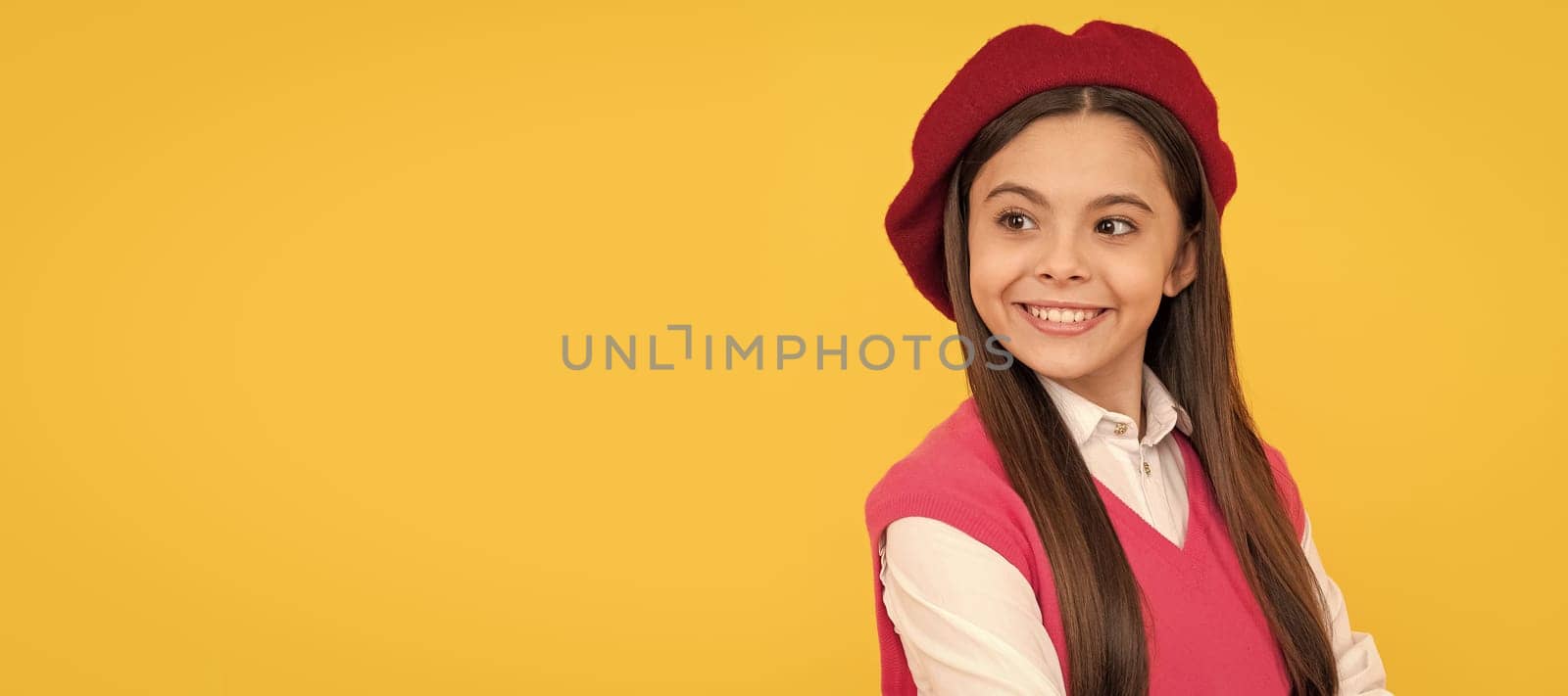 happy teen school girl in french beret on yellow background, smile. Child face, horizontal poster, teenager girl isolated portrait, banner with copy space. by RedFoxStudio