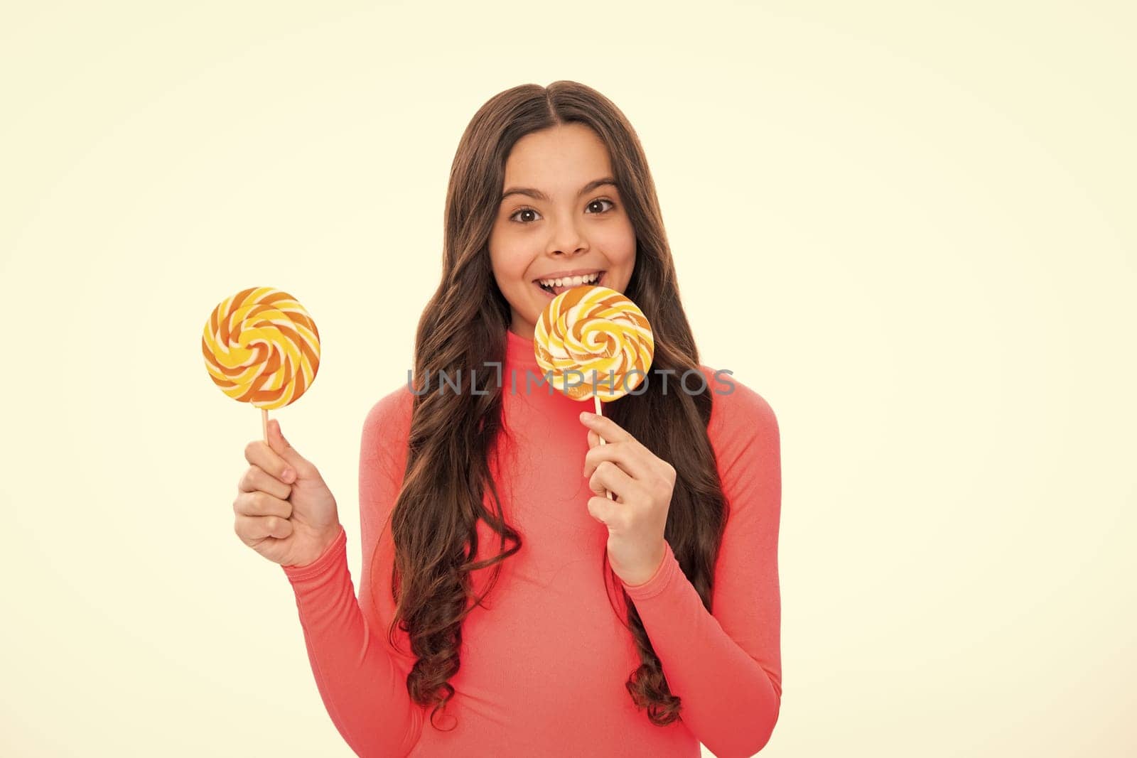 Teenage girl with candy lollipop, happy child 12, 13, 14 years old eating big sugar lollipop, sweets candy. Happy girl face, positive and smiling emotions. by RedFoxStudio