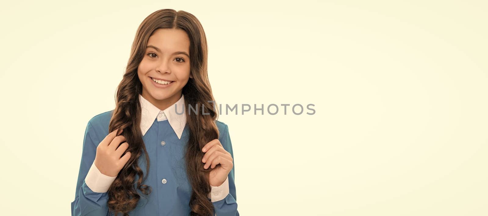 glad kid portrait has long curly hair isolated on white, beauty. Child face, horizontal poster, teenager girl isolated portrait, banner with copy space