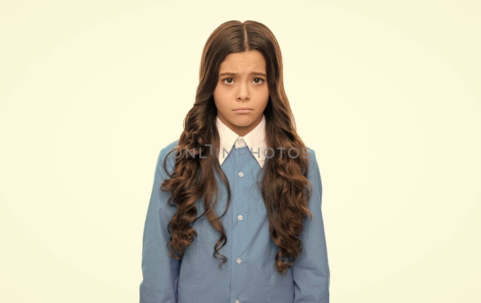 sad kid portrait has long curly hair isolated on white, emotions.